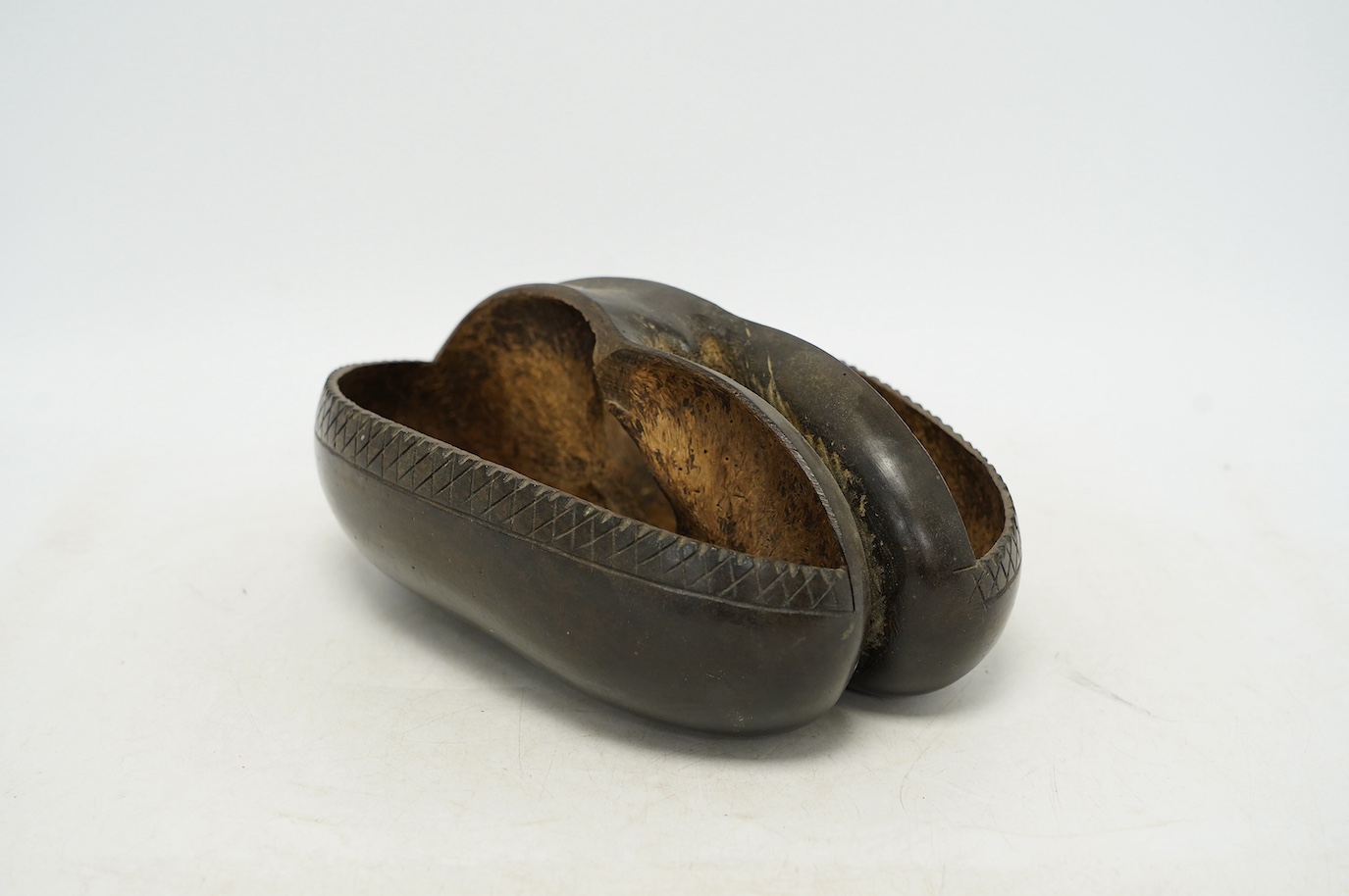 A coco de mer carved dish, 25cm wide, 18cm high. Condition - fair